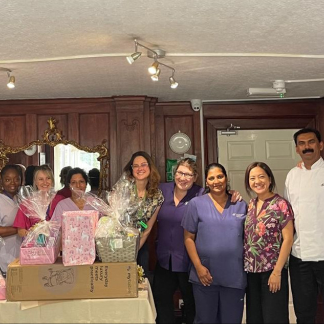 Staff gathered for a baby shower at the home