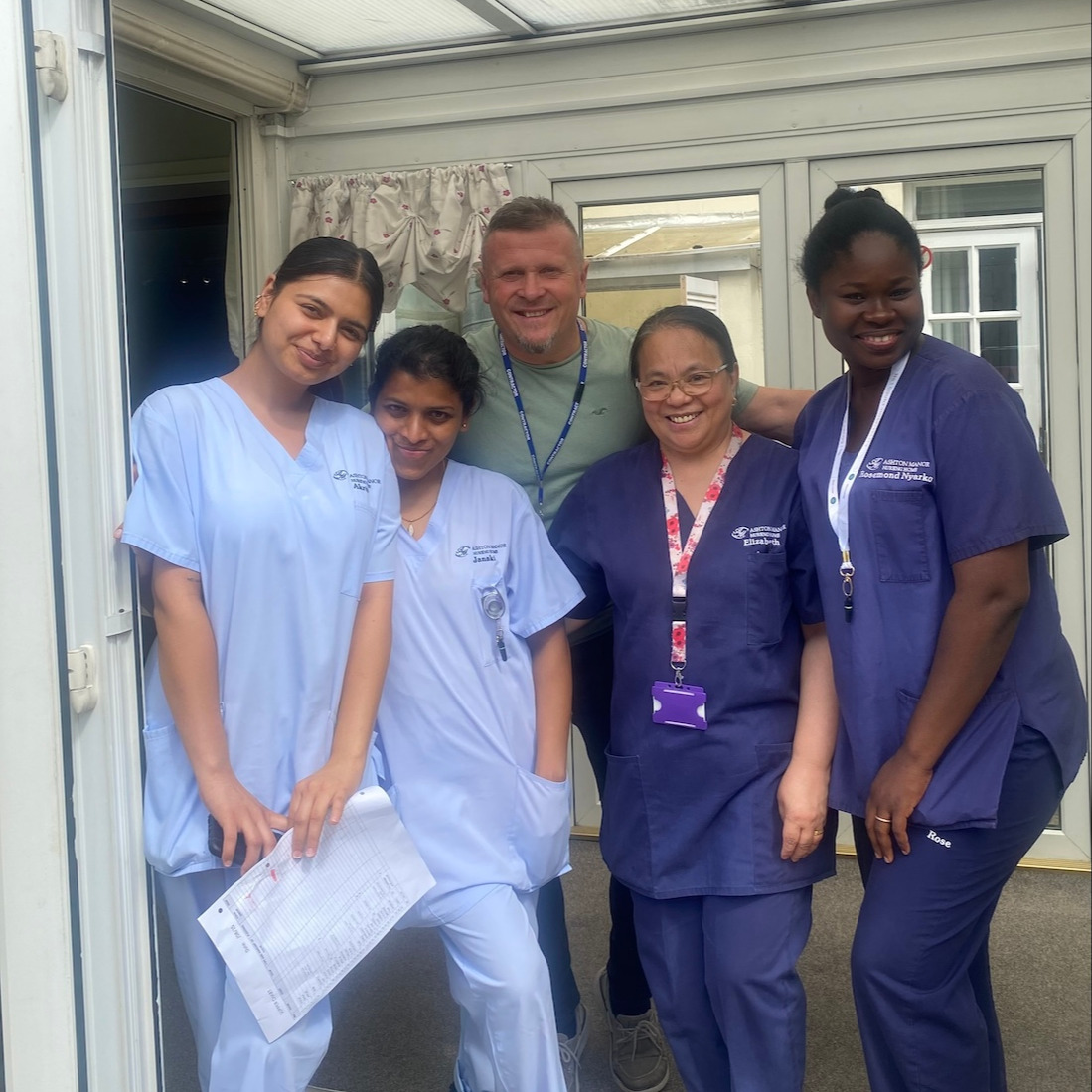 A group of home staff members smiling