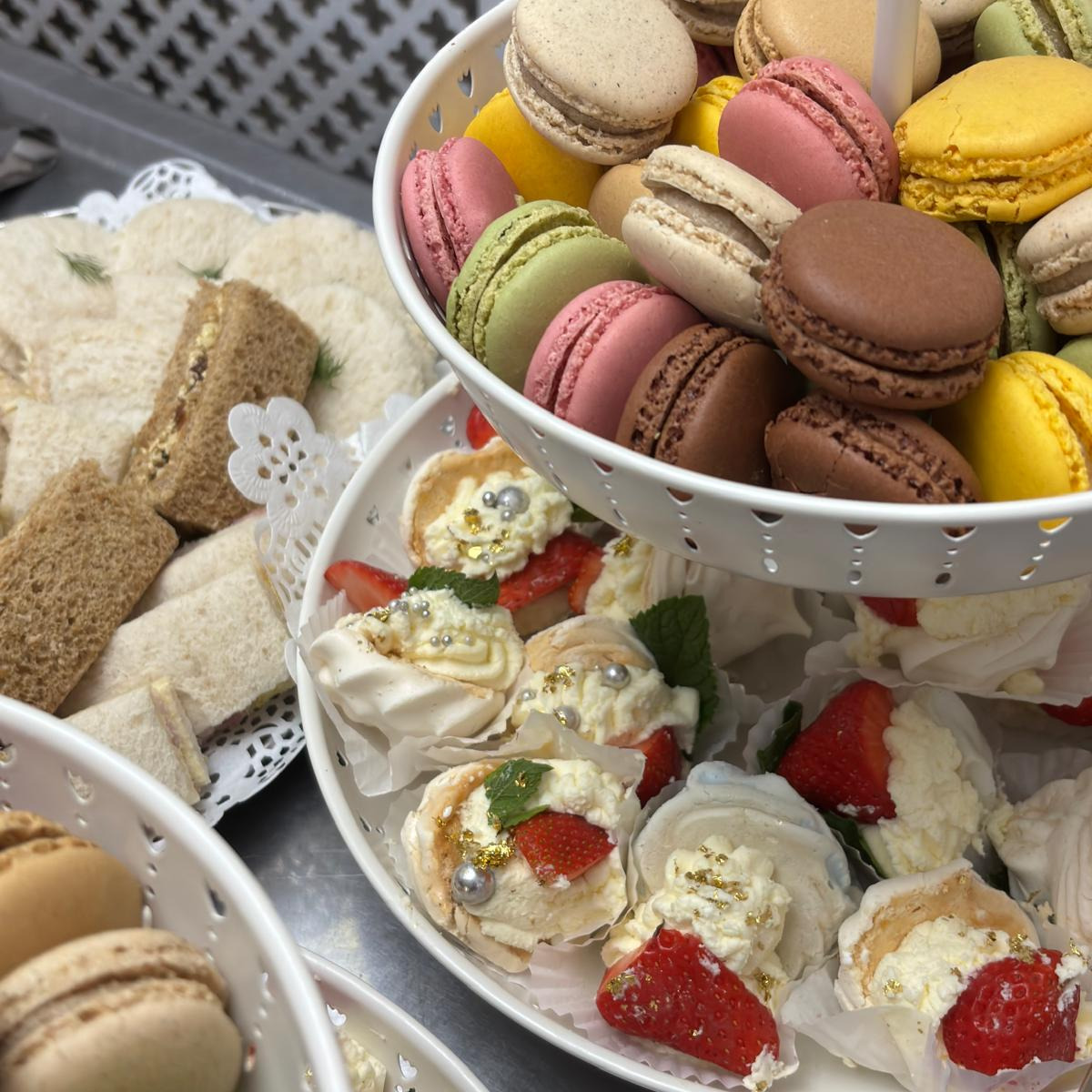 A table filled with sandwiches cakes and other party food