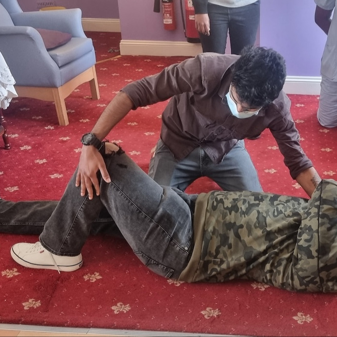 Staff members doing practical first aid training