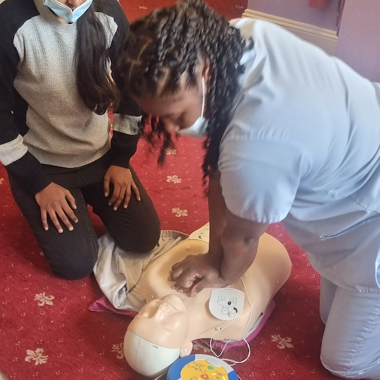 Staff members doing practical first aid training