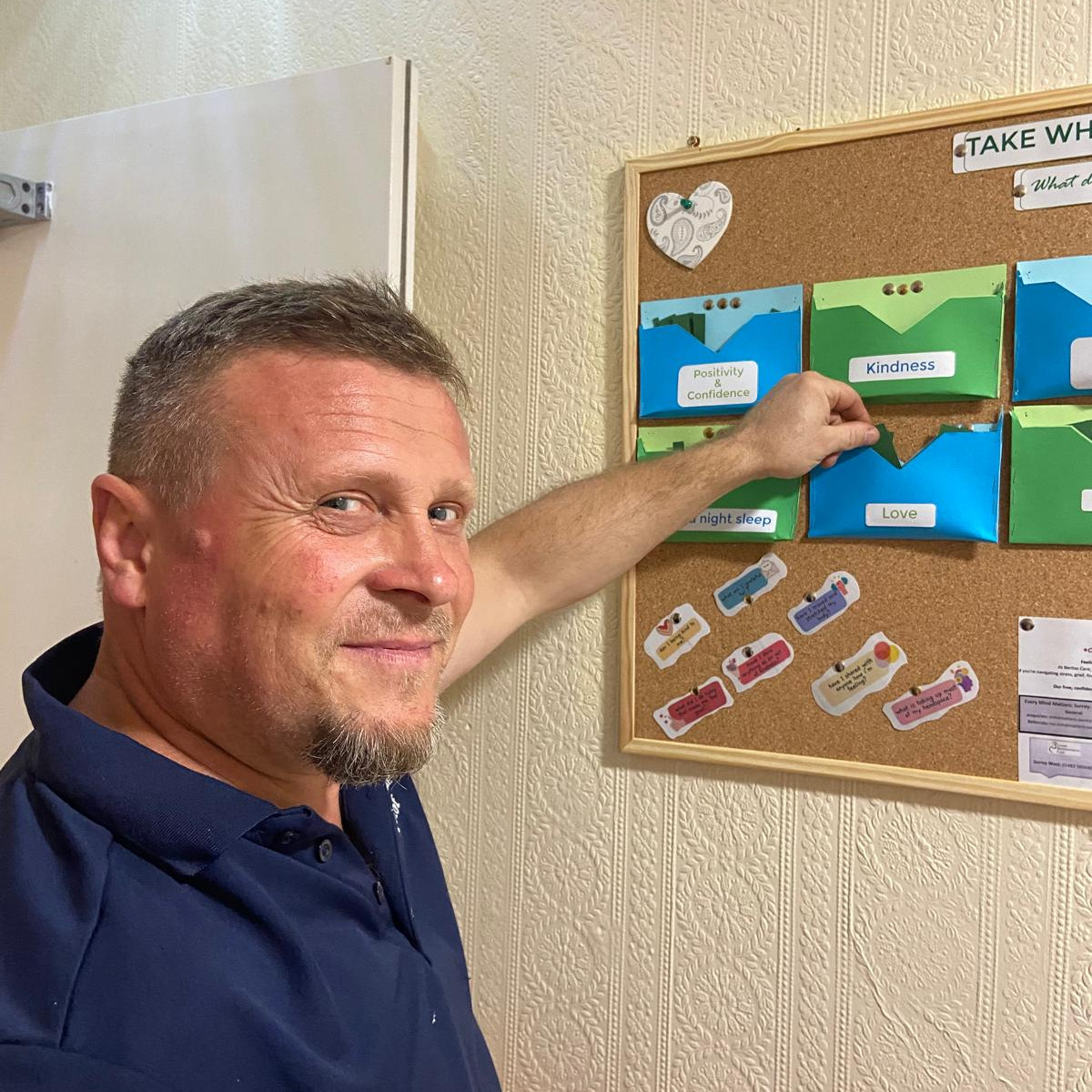 Staff member looking at a notice board