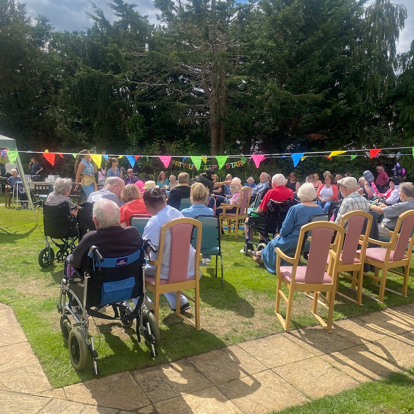 People at a summer garden party sat in chairs
