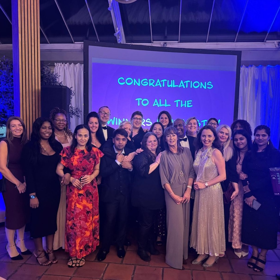 A group of people in formal wear at an awards event