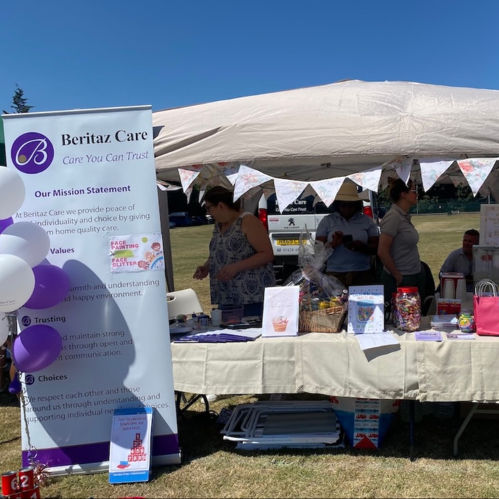 A stall at a fete with balloons and a Beritaz banner