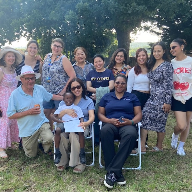 A group of people outside at a garden party