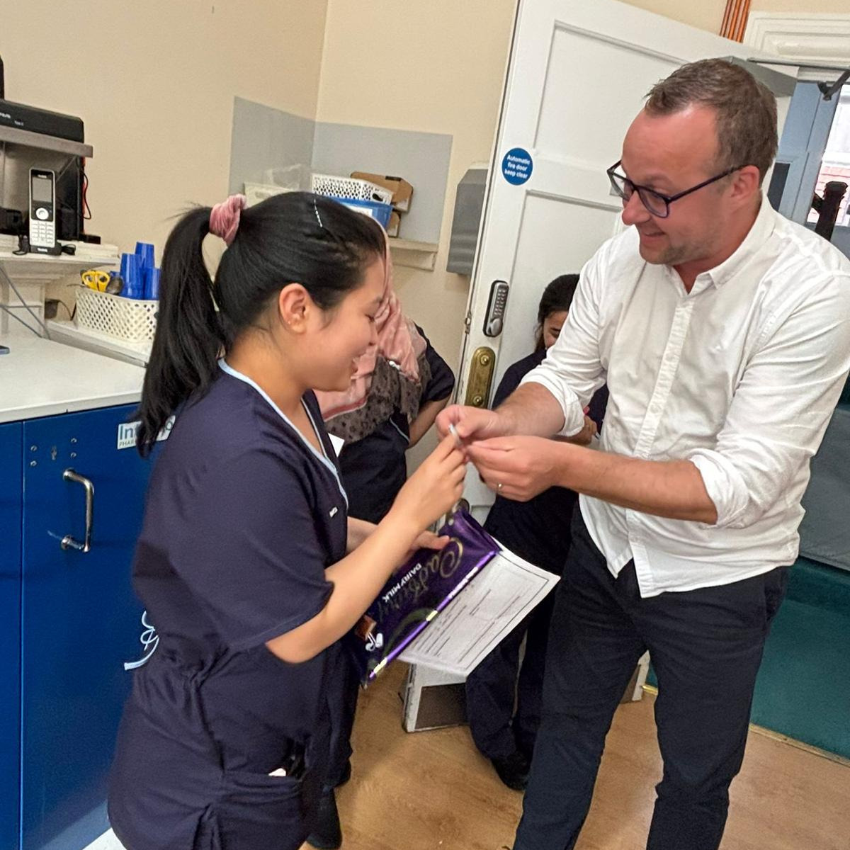 A staff member in uniform being given an award