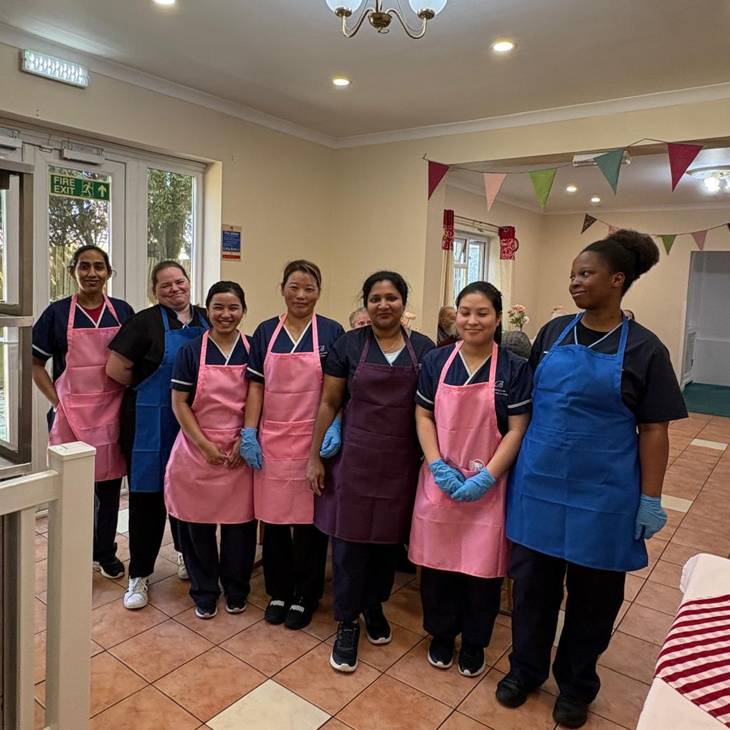 Staff members stood together wearing aprons