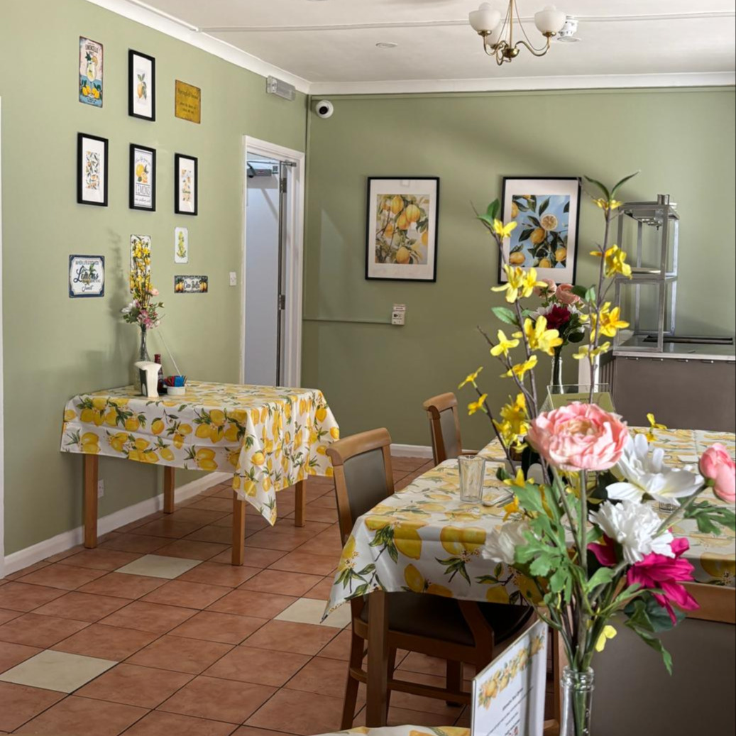 A bright dining room space with fresh flowers on the tables