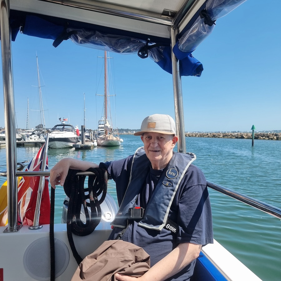 An older man sat on a boat