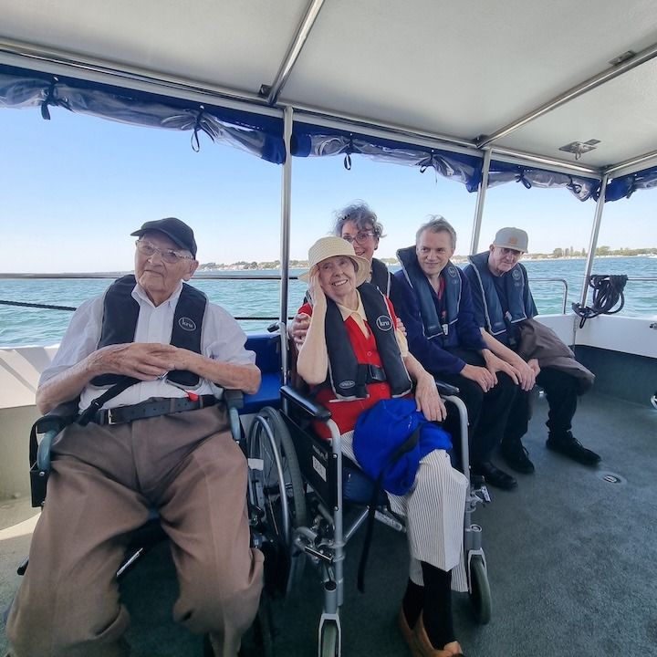 A group of people sat on a boat 