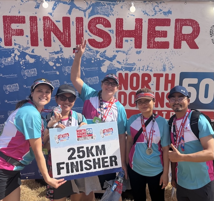 A group of people in sportswear in front of a race finish line