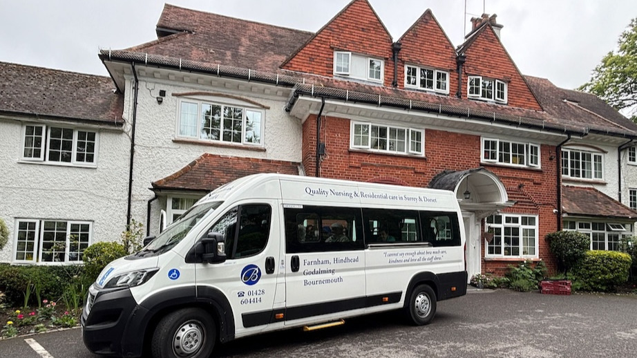 A minibus parked outside of a building