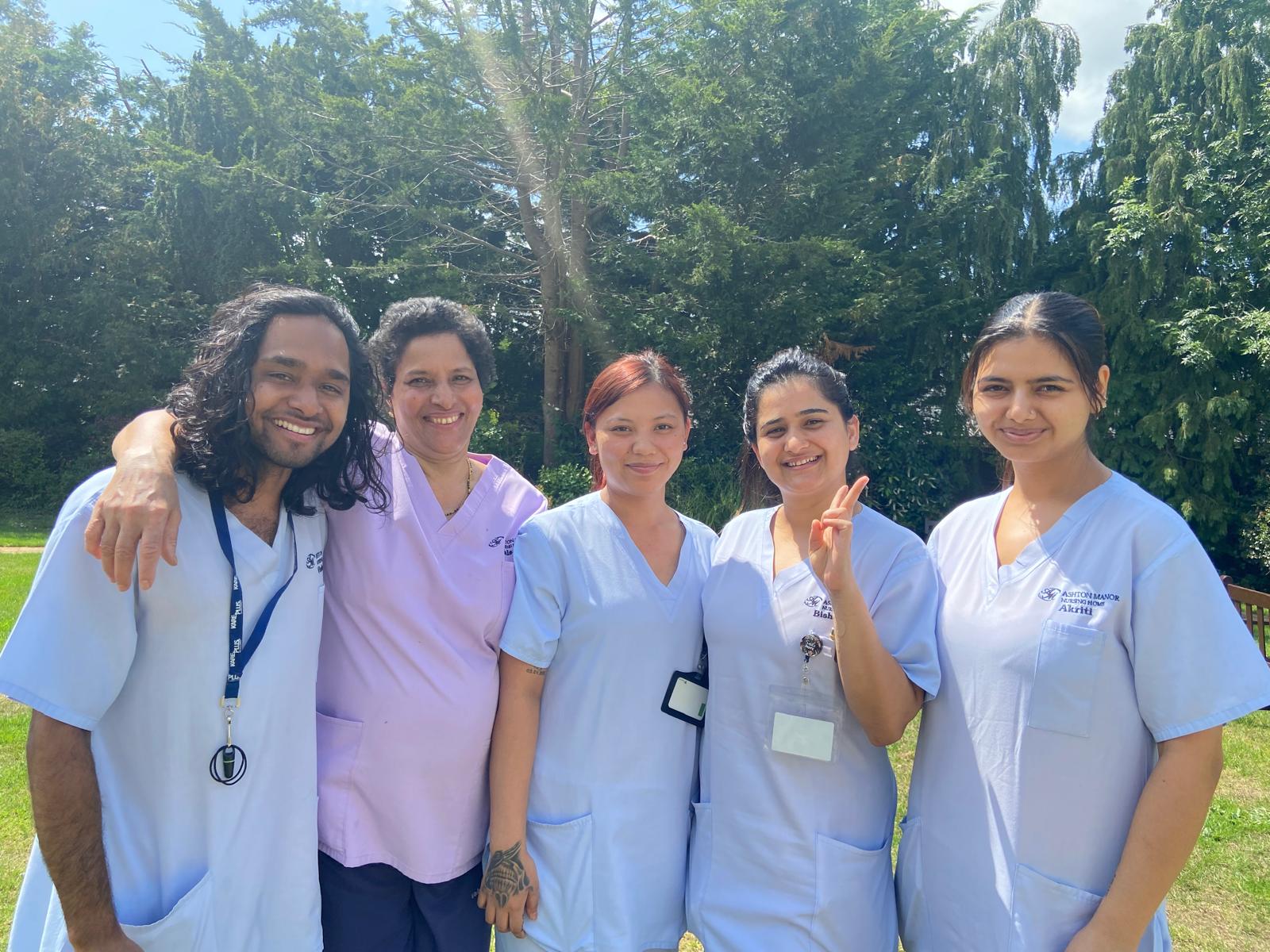 A group of people wearing medical uniforms outside