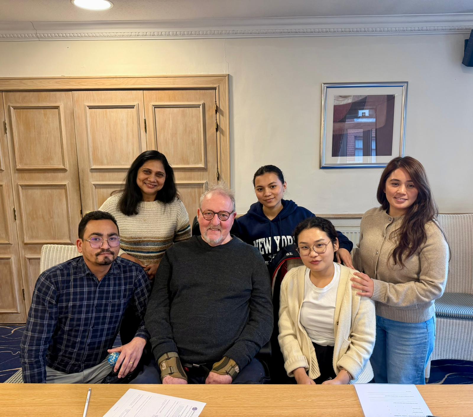 A photo of the Ashton Manor team with a resident in casual clothes at a training session
