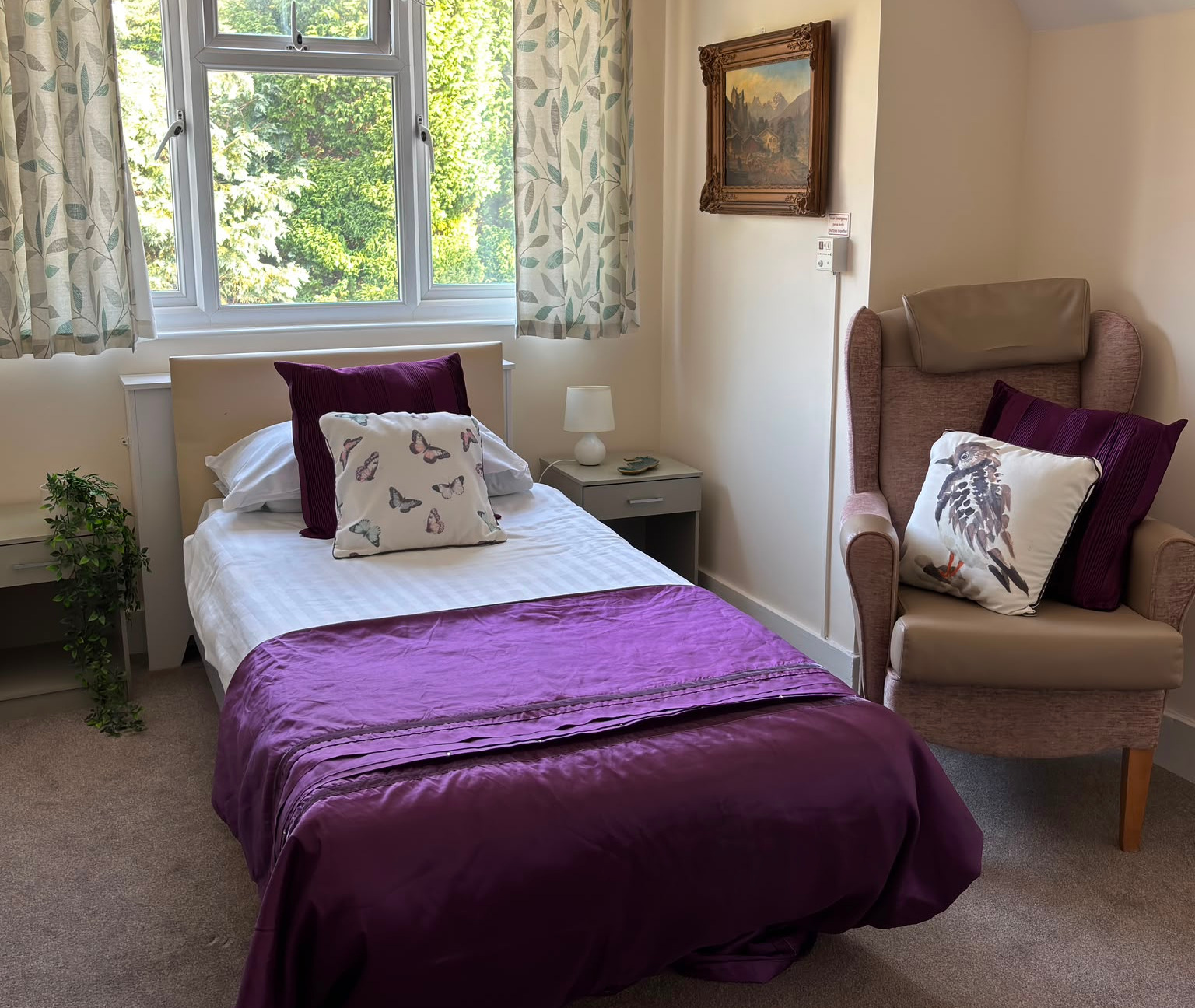 Comfortable bedroom with a comfortable bed in front of a window and armchair