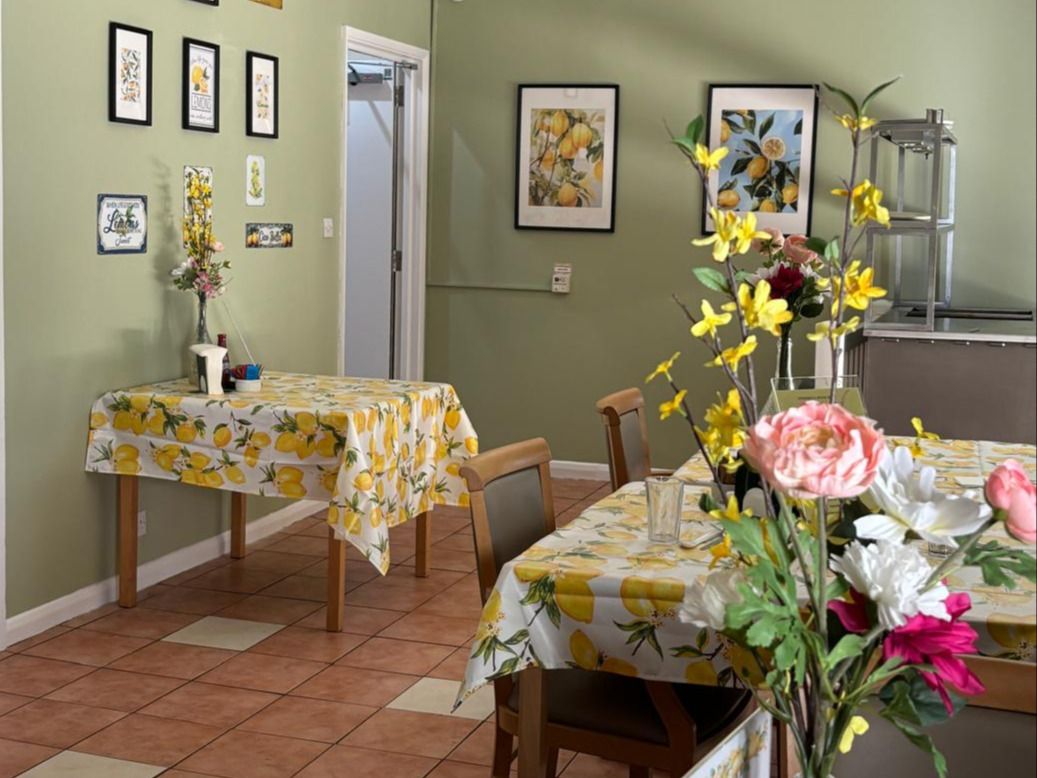 Bright and cheerful dining room with lemon decor and flowers