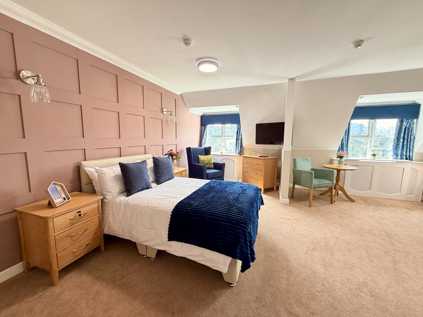 A comfortable room with large double bed and seating area