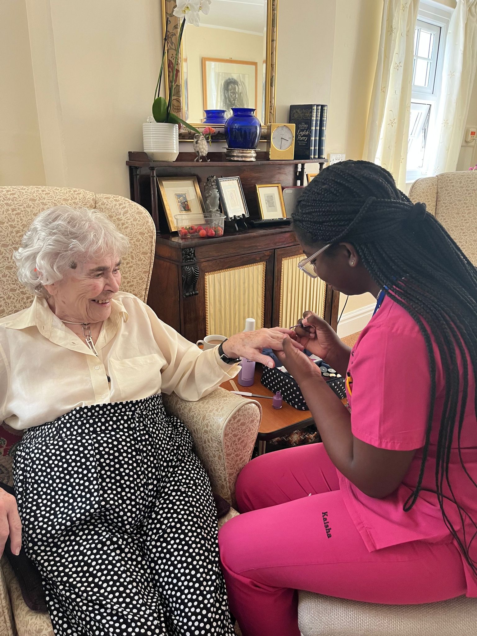 An elderly woman having a manicure done
