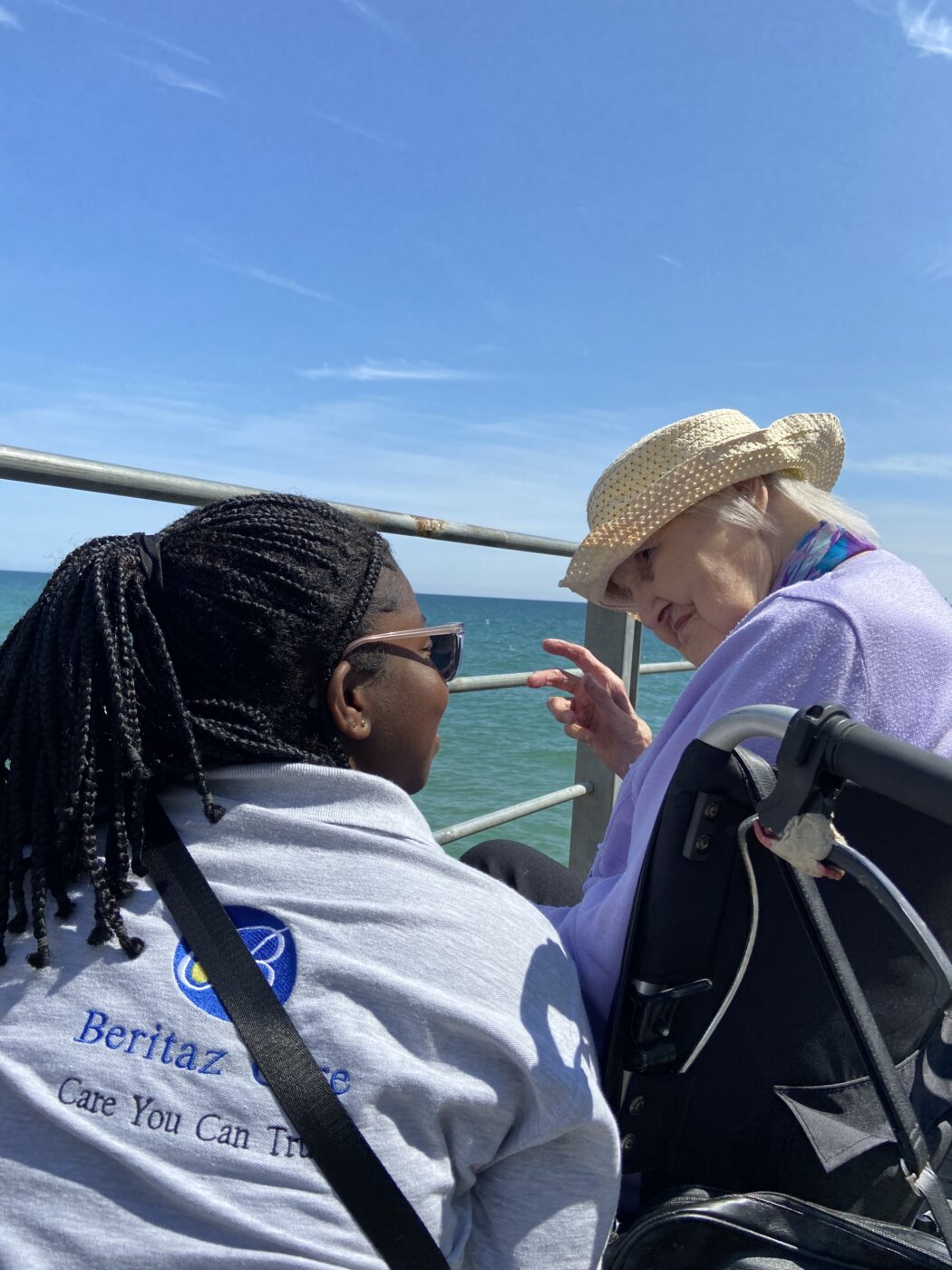 A care assitant with a resident on a pier