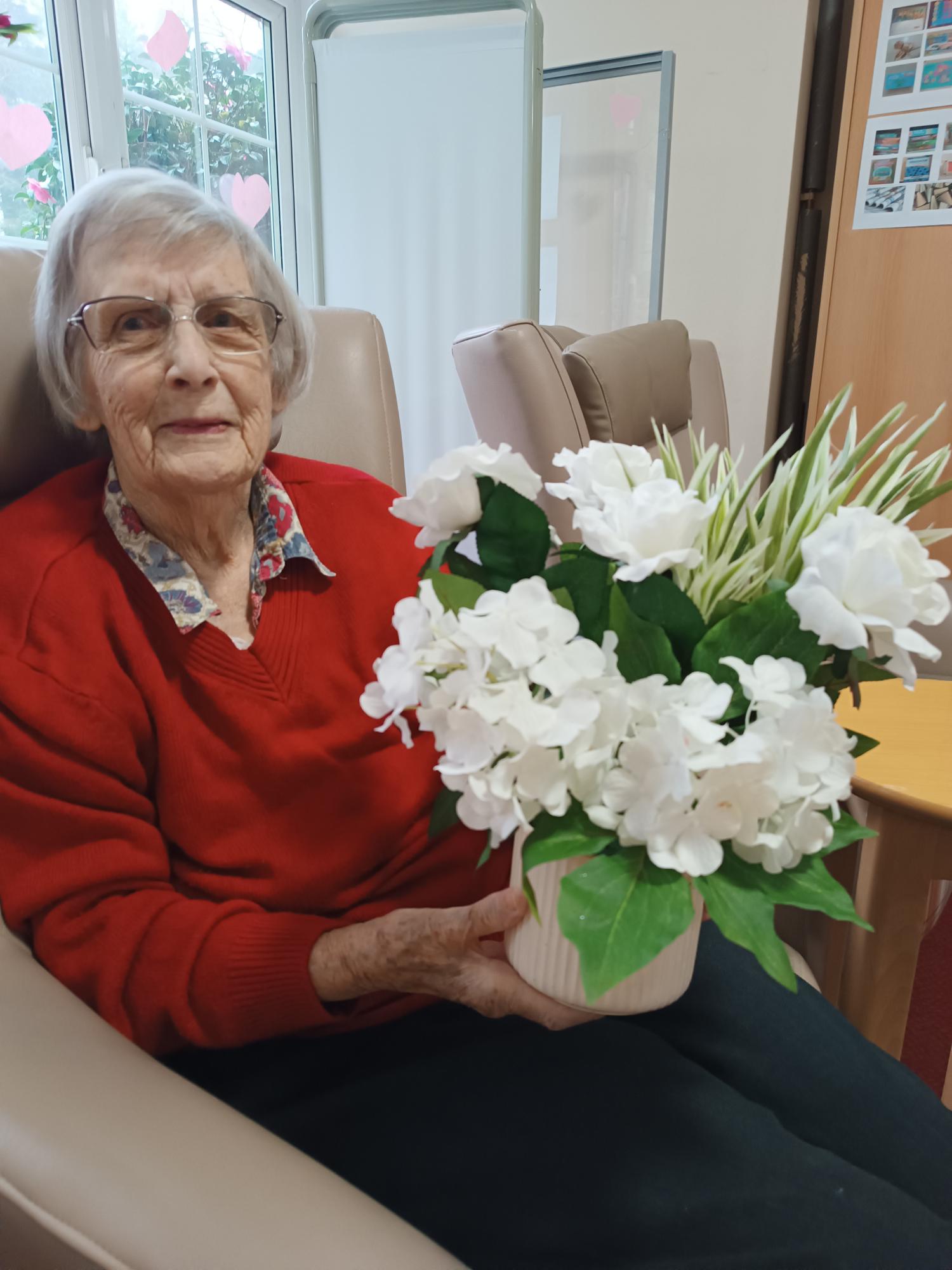 A lady holding a big bunch of white flowers