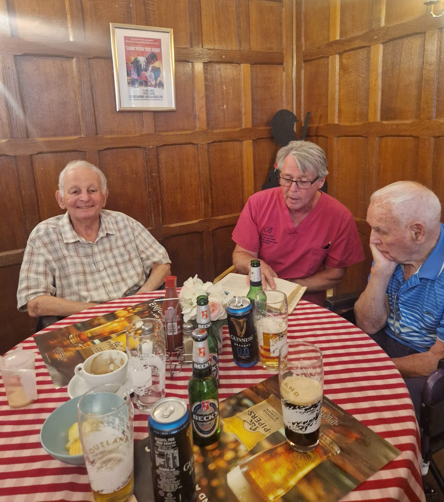 A group of people sat around a table enjoying refreshments