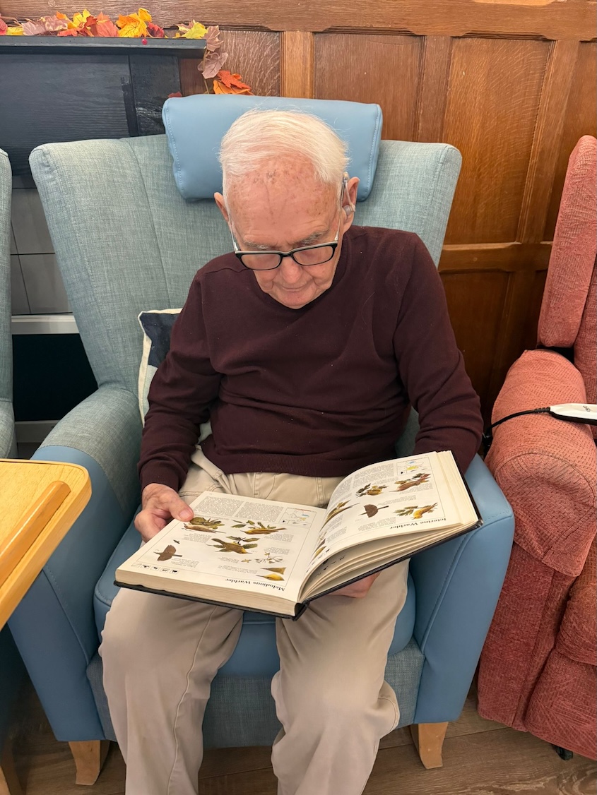 An older gentleman reading a book