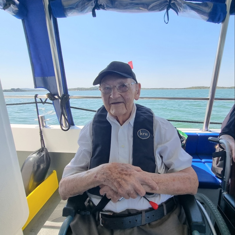 An older gentleman sat on a boat